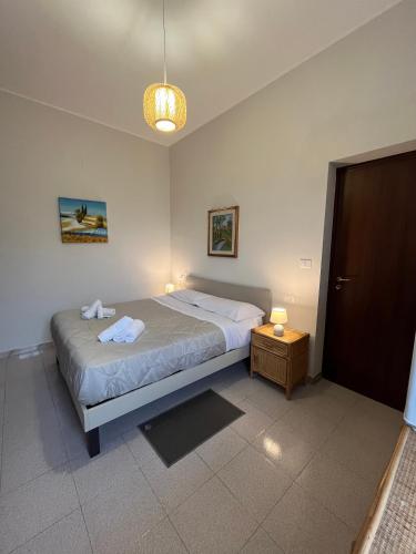 a bedroom with a bed and a table and a lamp at BnB La Casa di Monica in Silvi Paese
