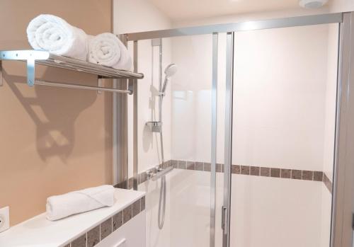 a bathroom with a shower and a glass shower stall at 4 - Seigneurie Fouquet - Caraquet in Le Palais
