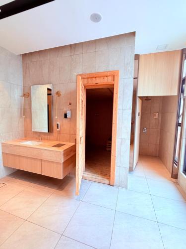 a large bathroom with a sink and a large mirror at Luxury Axon Suites KLCC-PAVILION in Kuala Lumpur