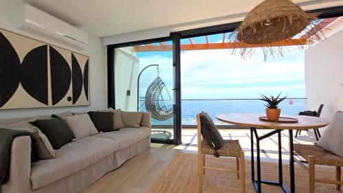 a living room with a couch and a table at Oasis House in São Roque