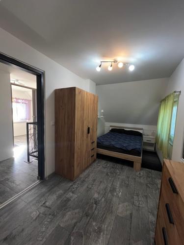 a bedroom with a bed and a wooden cabinet at Holiday house Habjanič in Gorušenjak