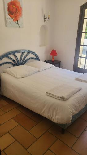 - une chambre avec un grand lit blanc et une lampe rouge dans l'établissement Villa La Louvière La Croix Valmer Golfe de Saint Tropez, à La Croix-Valmer