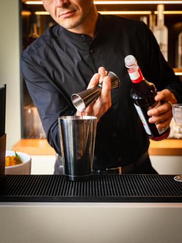 a man is stirring a drink in a blender at ananea Tropea Yachting Resort in Tropea