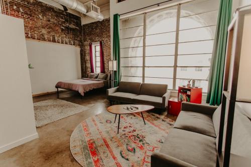 a living room with a couch and a table at The Downtown Art Loft in Memphis