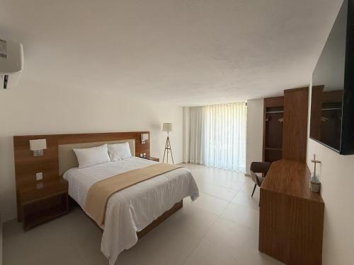 a bedroom with a bed and a television in it at Hotel Casa Kavia Vallarta in Puerto Vallarta