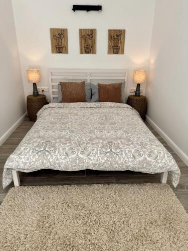 a bedroom with a large bed with two lamps at Stylish Boutique House - Turquoise - Outdoor Yard & Adjoining Cafeteria - Very Central! Near Valletta - Non-Sharing & Quiet in Hamrun