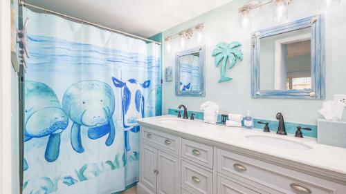 a bathroom with a whale shower curtain and a sink at Port Largo Villas Escape 5A in Key Largo