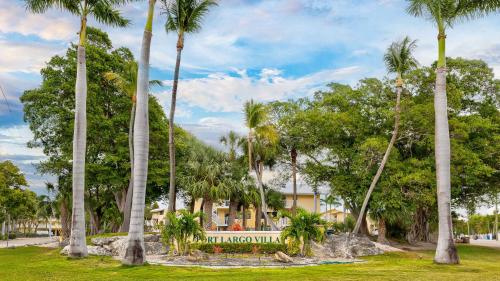 a group of palm trees in front of a resort at Port Largo Villas Escape 5A in Key Largo