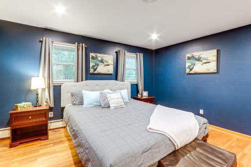 a bedroom with blue walls and a large bed at Less Than 1 Mi to Main St Rural Gem in Cherry Valley in Cherry Valley