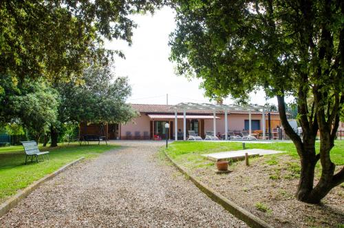 a building in a park with a bench and trees at Villa Asia, private villa with pool in Panicarola