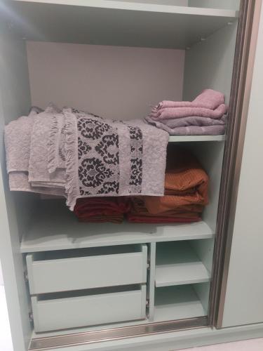 a walk in closet with towels and towels at Batumi in Itʼkhvisi