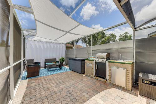 an outdoor kitchen with a tent in a kitchen with a table at Golf and Shop Gem with Private Pool in Boca Raton in Boca Raton