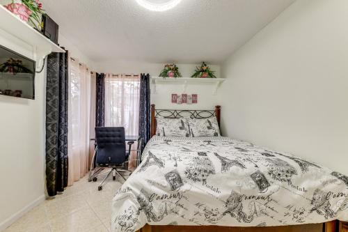 a bedroom with a bed and a chair in it at Golf and Shop Gem with Private Pool in Boca Raton in Boca Raton