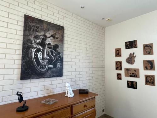 a room with a motorcycle painting on the wall at Maison à louer in Yèvres