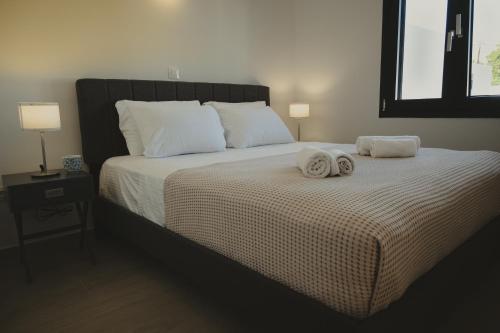 a bedroom with a large bed with towels on it at Modern Villa with Private Pool - Olive Grove in Ferma