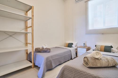 a bedroom with two beds and a window at Seaview Balluta-StJulians-Prime Spot in St Julian's