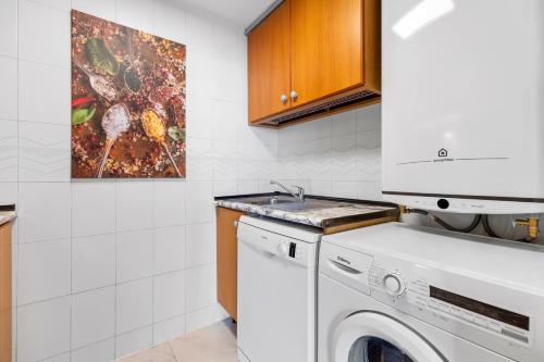 a kitchen with a washing machine and a sink at Apolo XI, Calpe, Modern Holiday Apartment, Sea view, Pool, 100m to Beach! in Calpe