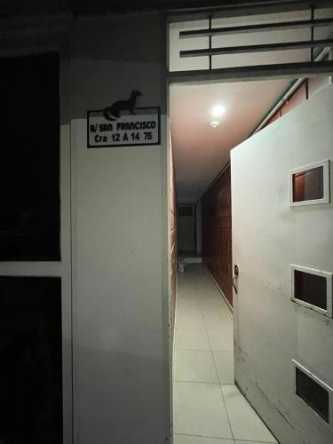 a door in a hallway with a sign on it at Tayra Living Suites in Mocoa
