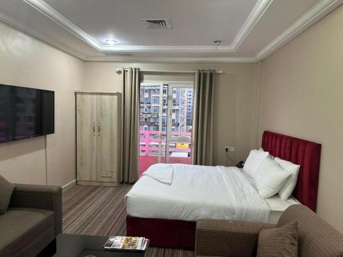 a hotel room with a bed and a couch at Pyramiza Fahaheel بيراميزا الفحيحيل in Kuwait