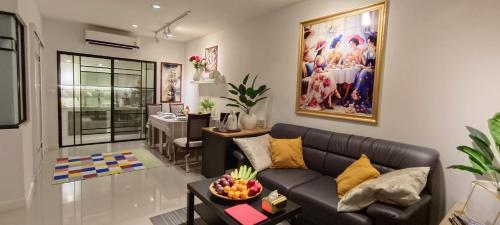 a living room with a couch and a table at Asia Boutique Club Residence 1 in Pathum Thani