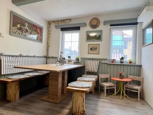 a restaurant with a wooden table and chairs and a counter at U Efy in Josefuv dul