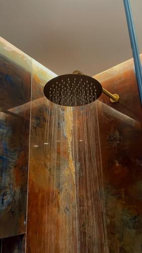 a hairbrush with water coming out of it at KLEOPATRA'S Luxury Suite in Preveza