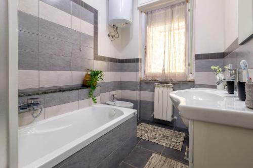 a bathroom with a tub and a sink at L'Angolo di Anna - Alghero, Italy in Alghero