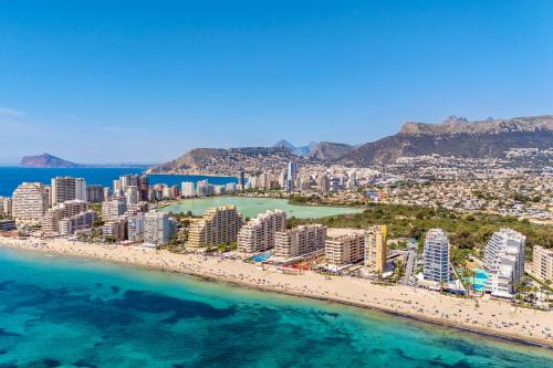 an aerial view of a beach with buildings and the ocean at Apolo XI, Calpe, Modern Holiday Apartment, Sea view, Pool, 100m to Beach! in Calpe