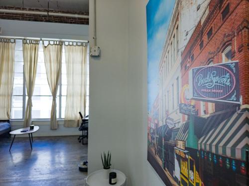 a living room with a mural on the wall at The Downtown Factory Loft in Memphis