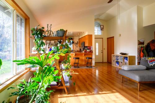 a living room filled with lots of plants at River House - 4 bedroom, 2 bath private home in Eugene