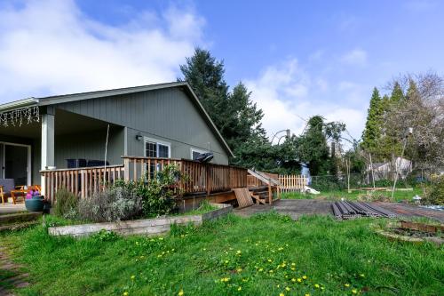a house with a deck and a roller coaster at River House - 4 bedroom, 2 bath private home in Eugene