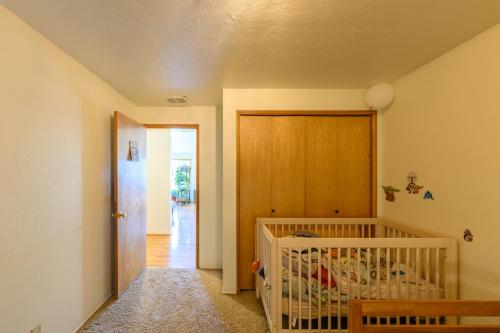 a baby crib in a room with a wooden door at River House - 4 bedroom, 2 bath private home in Eugene