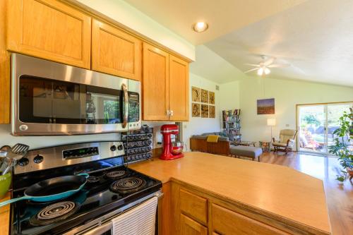 a kitchen with a stove and a microwave at River House - 4 bedroom, 2 bath private home in Eugene