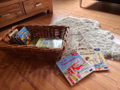a basket of books and magazines on the floor at Ferienwohnung am Reichenbach in Hechingen