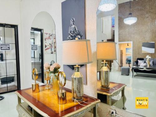 a living room with two lamps on a table at Upper East Inn- Bacolod in Bacolod