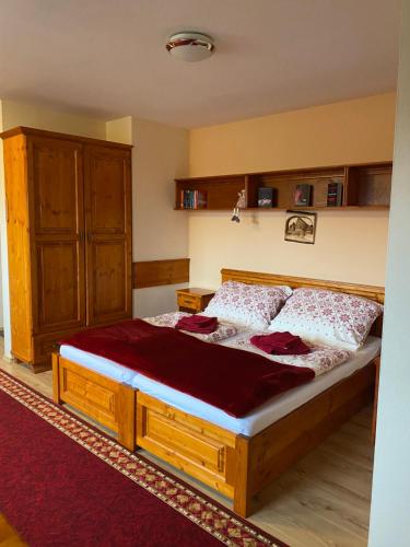 a bedroom with a large wooden bed in a room at Apartmán Dorian in Bešeňová