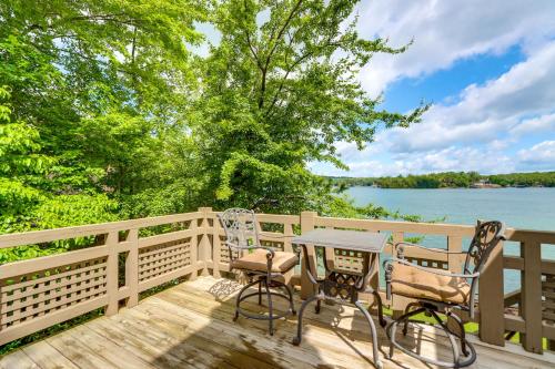 a table and chairs on a deck with a view of the water at Waterfront Escape on Blue Ridge Lake with Dock! in Morganton