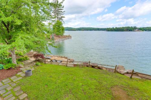 a view of a lake with a fence and grass at Waterfront Escape on Blue Ridge Lake with Dock! in Morganton