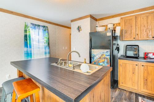 a kitchen with a sink and a refrigerator at Pet-Friendly Punta Gorda Getaway with Fire Pit! in Punta Gorda