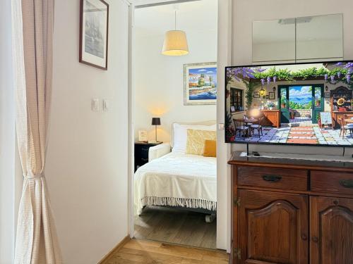 a bedroom with a bed and a flat screen tv at Viola Apartment in Poreč