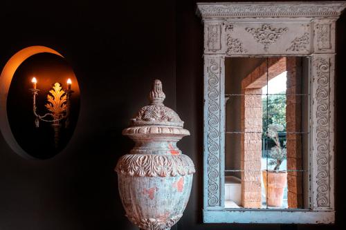 a vase sitting on a table next to a mirror at SWISS MORAIRA HOTEL & SPA - Adults only in Moraira