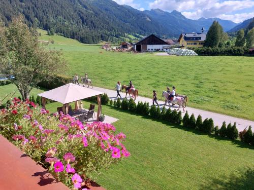 a group of people riding horses down a road at Landhaus Tripolt in Radstadt