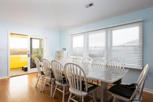 a dining room with a table and chairs at Semi Ocean Front Luxury Home Pool Spa Game Room in Duck