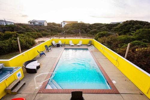 a large swimming pool on top of a building at Semi Ocean Front Luxury Home Pool Spa Game Room in Duck