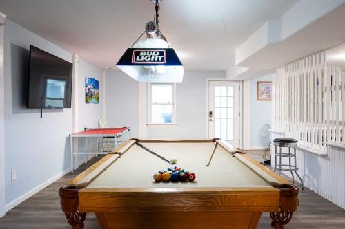 a pool table in a living room with a ceiling at Semi Ocean Front Luxury Home Pool Spa Game Room in Duck