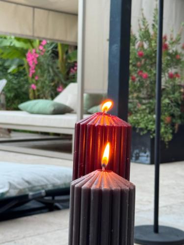 a red candle sitting on top of a table at Maison Jacotte orange in Orange
