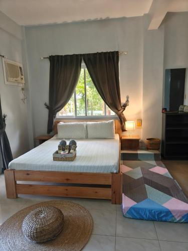 a bedroom with a large bed with a window at Family 2 bed apartment with stunning sea views in Puerto Galera
