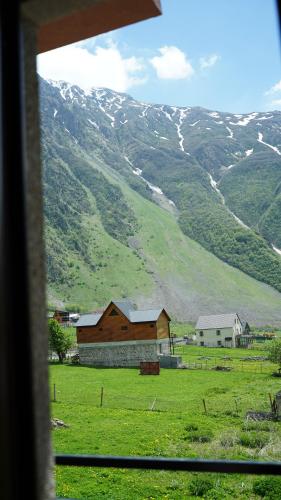 a view from a window of a field with a mountain at OISHE Boutique Hotel in Stepantsminda