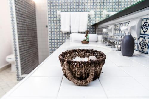 a bathroom with a basket on a counter at ANANA Rancho San Rafael Pool and Lake Views in Ajijic
