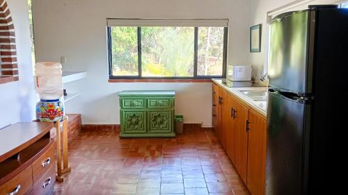a kitchen with a green refrigerator and a window at ANANA Rancho San Rafael Pool and Lake Views in Ajijic